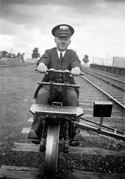 Guard sitting on a ganger's trolley, Ingliston Railway Station, 1939