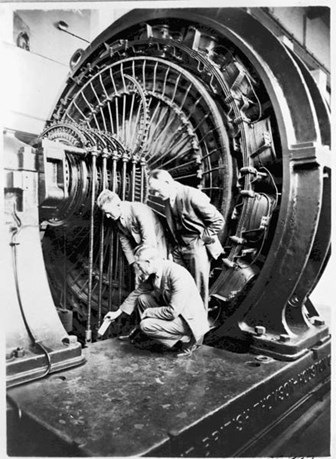 Inspecting rotary converter at railways substation, circa 1920s