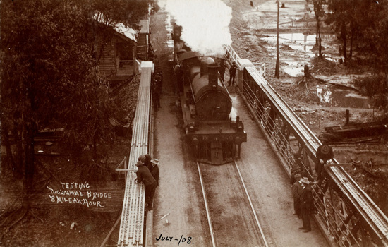 A DD class (DD 636) steam locomotive passing over and testing the road and rail bridge over the Murray River, Tocumwal, on the Strathmerton to Tocumwal line, July 1906