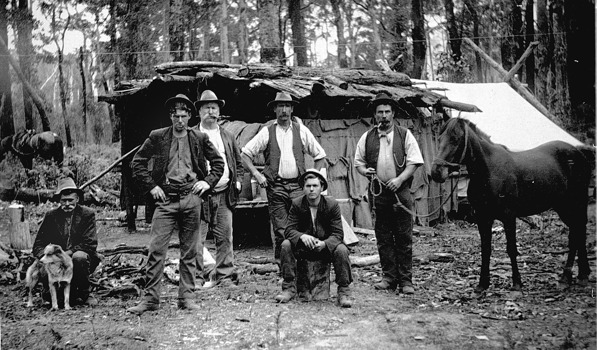 Railway workers in front of a slab hut, Bairnsdale to Orbost line, Simpson's Creek, 1914