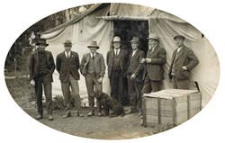 Seven members of the Engineering Construction Branch in front of a tent during the construction of the bridge over the Murray River at Gonn Crossing on the Murrabit to to Stony Crossing line, circa 1928