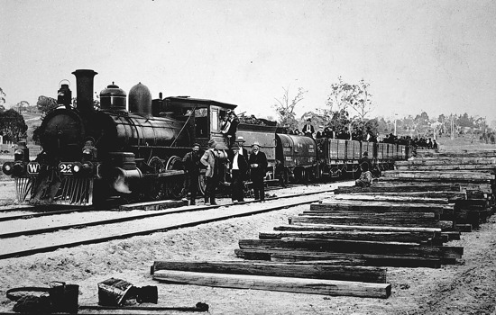 Locomotive with rail trucks carrying groups of men, Bruthen district, circa 1915