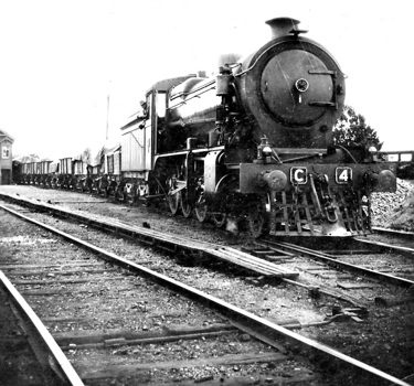 C class steam locomotive no. 4 hauling trucks, circa 1930