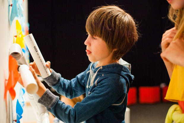 Boy interacting with a windmill display
