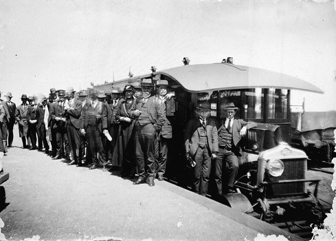Men standing beside the motor rail, Sea Lake Railway Station, circa 1920