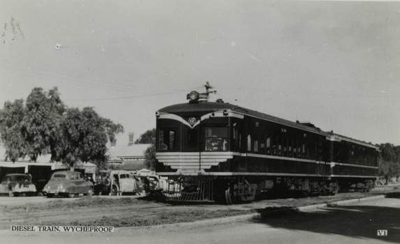 Two carriage diesel train with Victorian Railways logo on its front, Wycheproof, post-1935