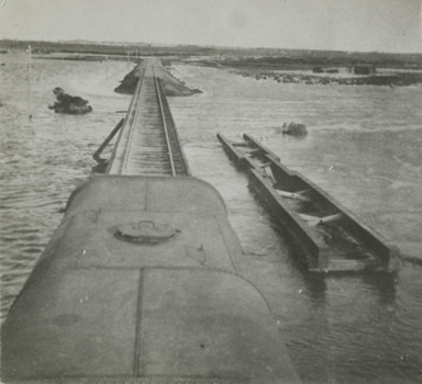 Train crossing a bridge over the flooded Powlett River, 1934