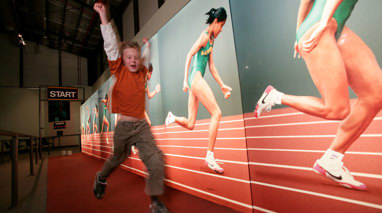 Boy racing against Cathy Freeman at Sportsworks