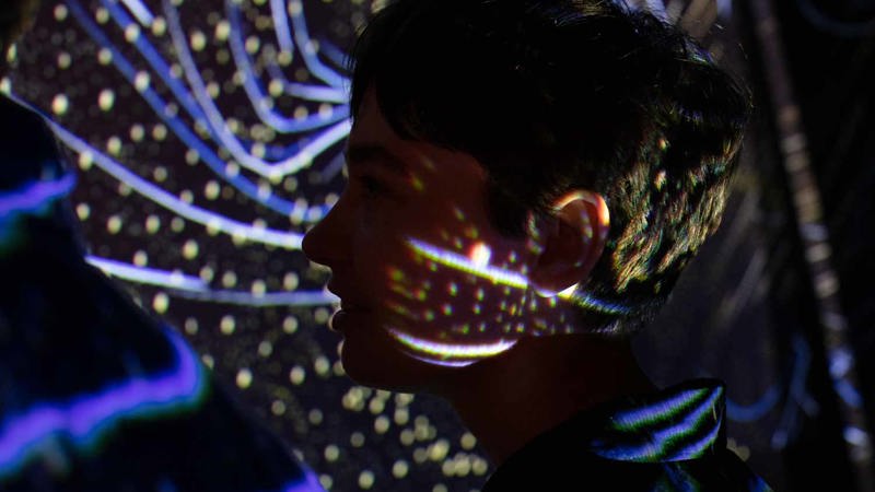 Person standing in a light projection
