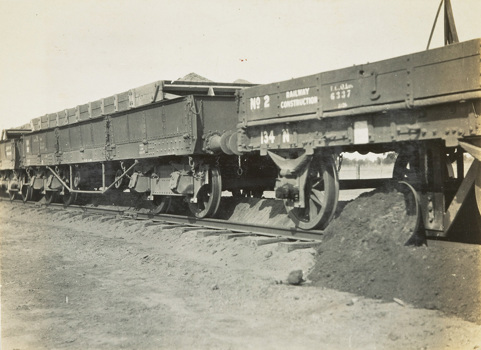 Construction of the Yarrawonga to Oaklands line, Yarrawonga, circa 1930. Ballast has been dropped from a hopper truck in the middle of the track and the ballast plough, attached to the underside of the rear rail trucks, is being spread by a v-shaped mould board.