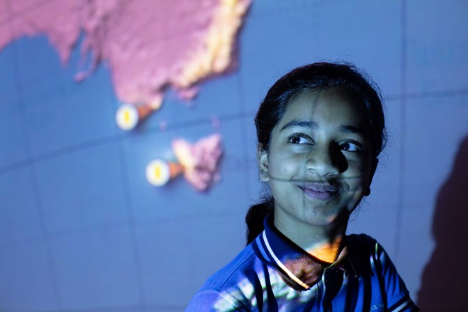 School student with light projected over their face