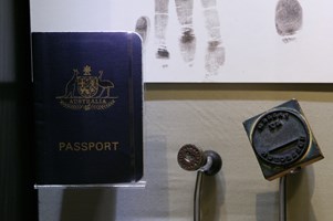 Showcase displaying passport and stamp at the "Getting In" exhibition