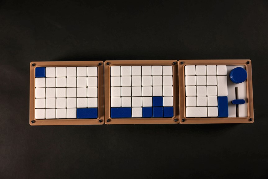 Three sections of a compact keyboard, displaying white and blue keys.