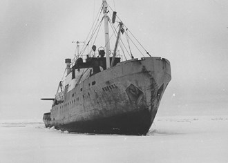 An icebreaker ploughs through a sheet of ice. 