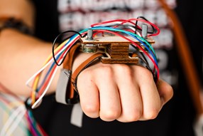 Detail of A.T.O.M. Humanoid Robot's Cables and Hand Brace connected to Human Hand