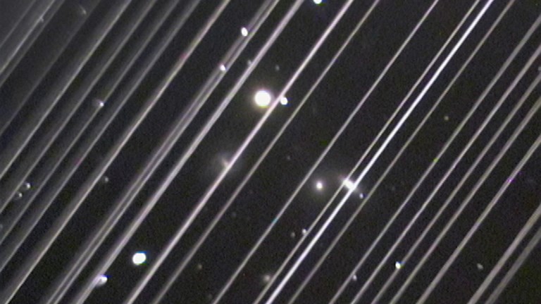 Streaks and dots of light on a black background