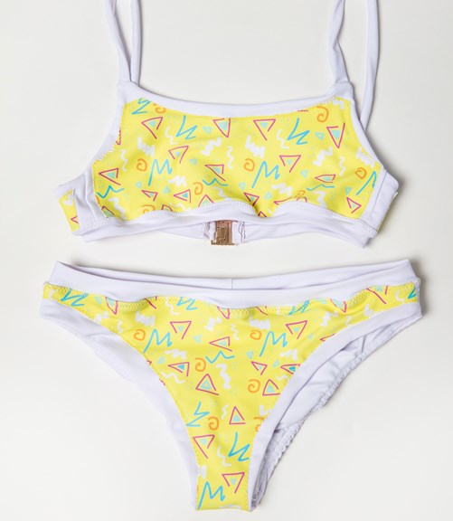 A bikini pair is laid out. They are primarily patterned with a yellow graphic 80s print. They have a white border.