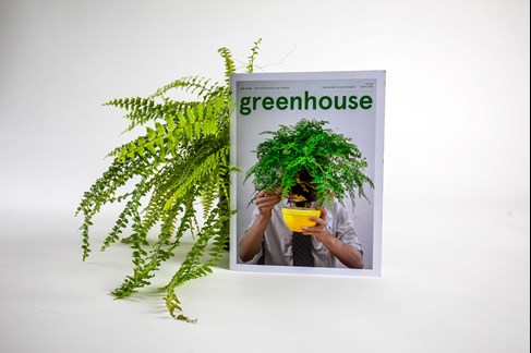 Greenhouse magazine is propped up against a pot plant