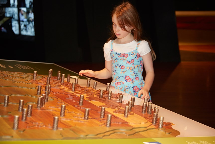 Girl looking at a museum interactive