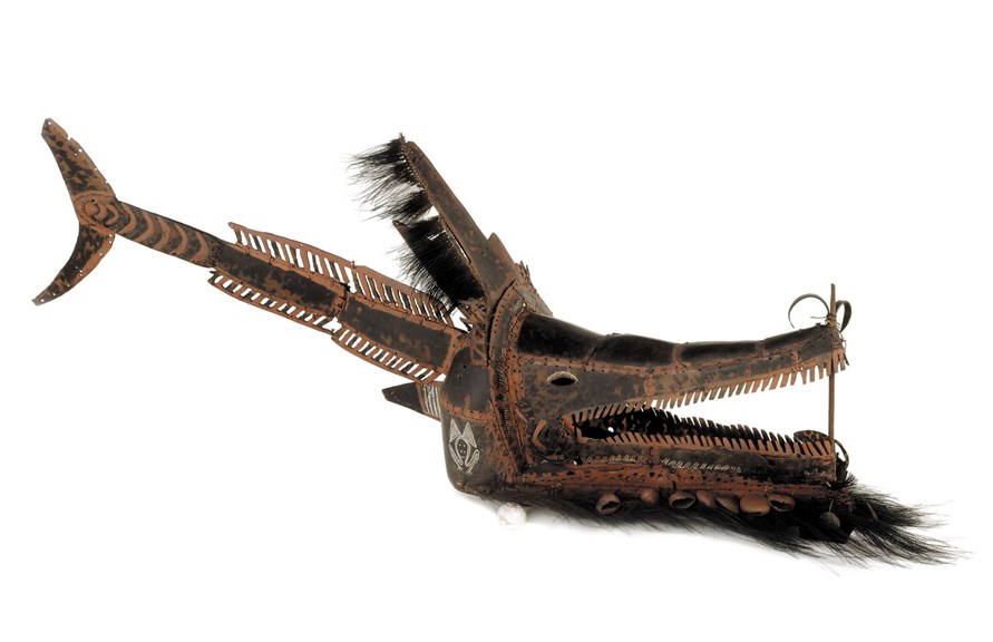 A headdress in the form of a crocodile with a fish tail. 