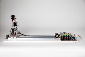 Side view of robotic arm, made of clear acrylic, with circuit boards and electrical components visible