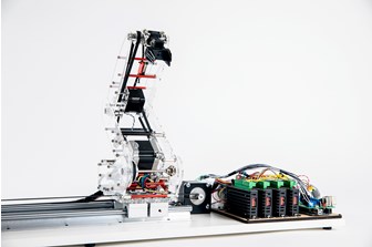 Angle view of robotic arm, made of clear acrylic, with circuit boards and electrical components visible