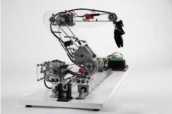 Profile view of robotic arm, made of clear acrylic, with circuit boards and electrical components visible