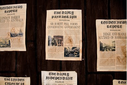 Detail of front pages of newspaper articles 