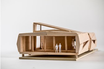Wide shot of a the front of miniature balsawood model of a portable classroom