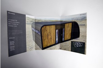 Inside the leaflet shows a digital rendering of a housing structure in the dessert, titled 'Arch Design'