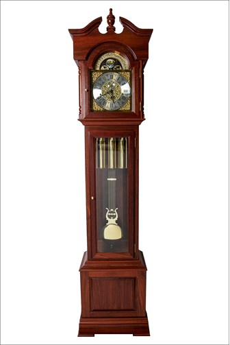 A tall wooden granfather clock with an engraved metal clock face