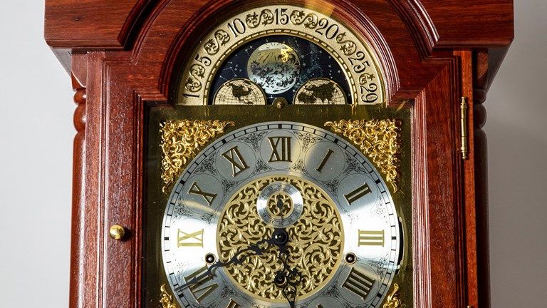 Close up of metal engravings on clock face