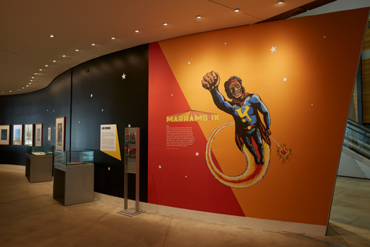 Entry signage for the Marramb-ik (I Am) exhibition of Koori comics and graphic novel artwork, in the Birrarung Gallery, Bunjilaka