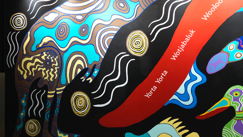 Section from the wall of the Birrarung Gallery featuring a 28 metre mural in honour of Victoria's 44 language groups