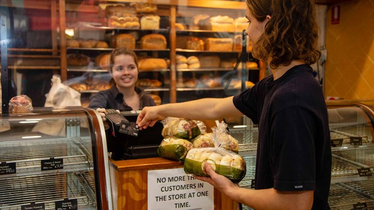 Shopper buying bread at a bakery