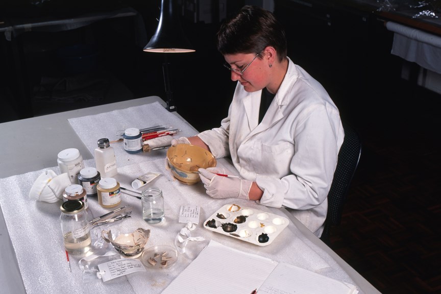 Museum worker working with objects