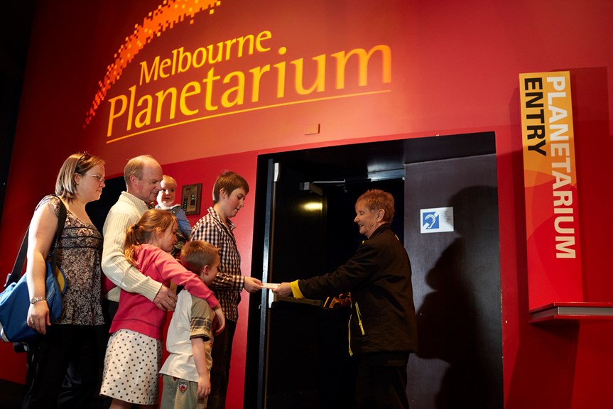Family lining up for the Melbourne Planetarium getting tickets scanned