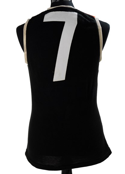 The back of a black guernsey with a white number 7. 