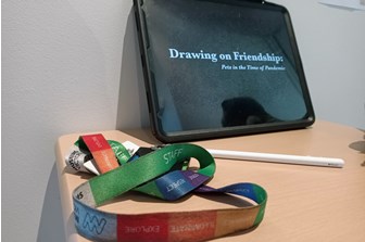 A lanyard and iPad on a card table