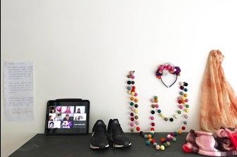 Ipad, runners, garland and scarves displayed on a bench top
