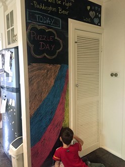 Boy drawing on a chalk board