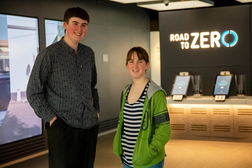 Two teenagers standing at the entrance of the Road to Zero Experience Space, located on the lower ground at Melbourne Museum