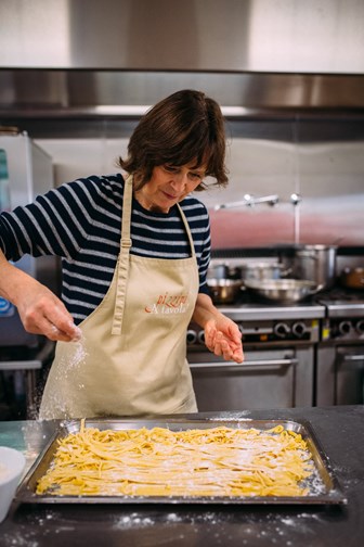 A women makes pasta. 
