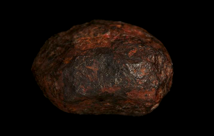 A reddish round rock.