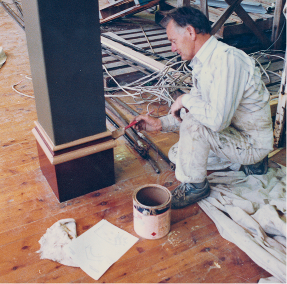 A worker restoring the interior of a buidling. 