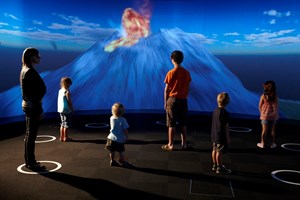 Visitors two adults and 4 children viewing 3D theatre