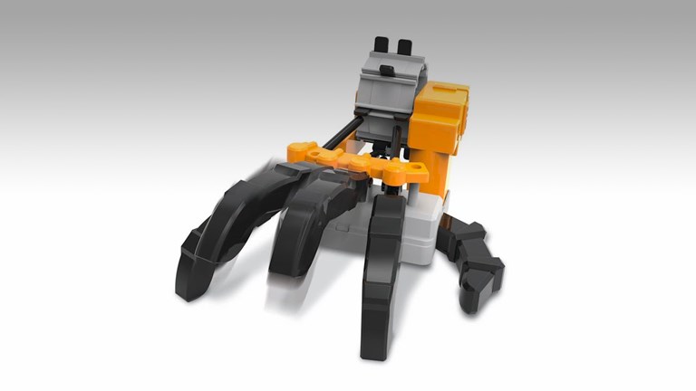 A black, grey and yellow plastic robot hand
