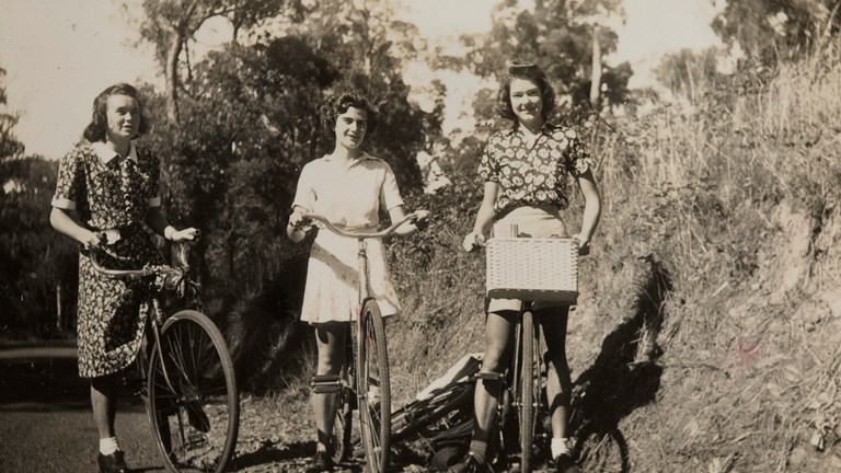 Three girls riding their bikes to Ferntree Gully, 1940.