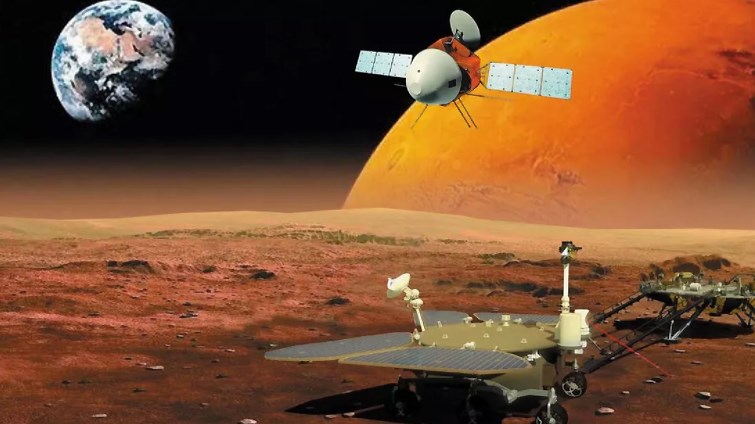 The three elements to China’s mission – orbiter above, lander at right and rover (solar panels unfolded) in foreground. This artist’s impression includes for effect an oversize Earth and extra Mars.
