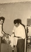 Ugo Ceresoli and his brother Bruno Ceresoli washing up in the kitchen of the boarding house at 230 Palmerston Street, Carlton, where they rented accommodation